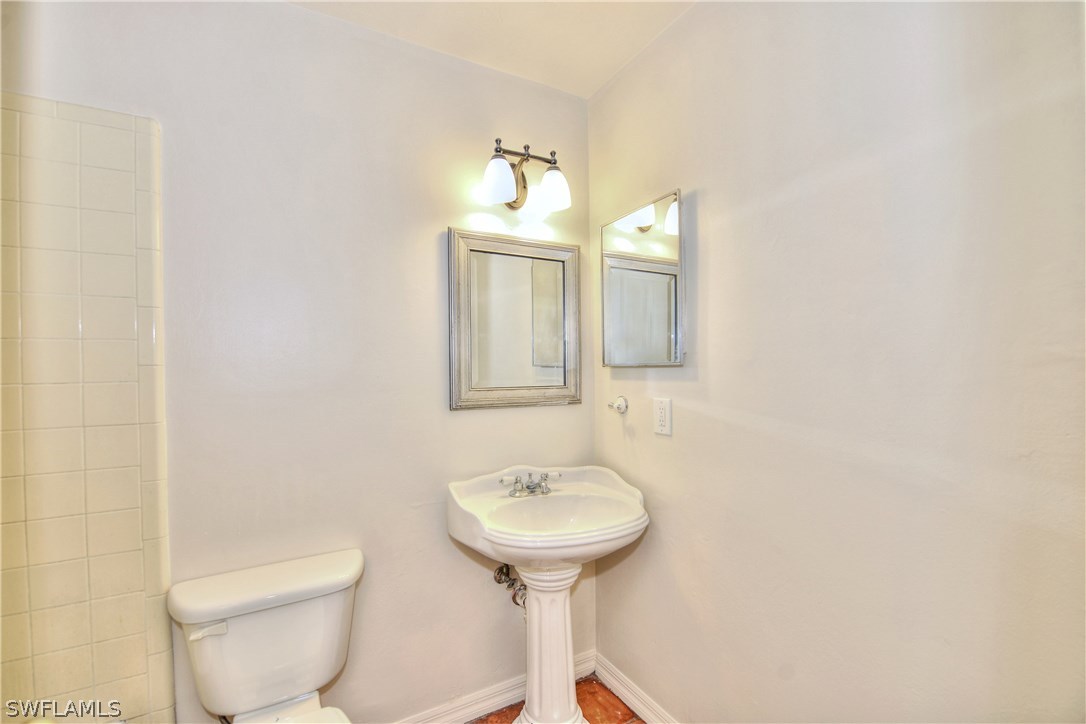 9321 Sedgefield Road North Fort Myers, FL 33917 - Photo 20 of 26 a bathroom with a toilet sink and mirror