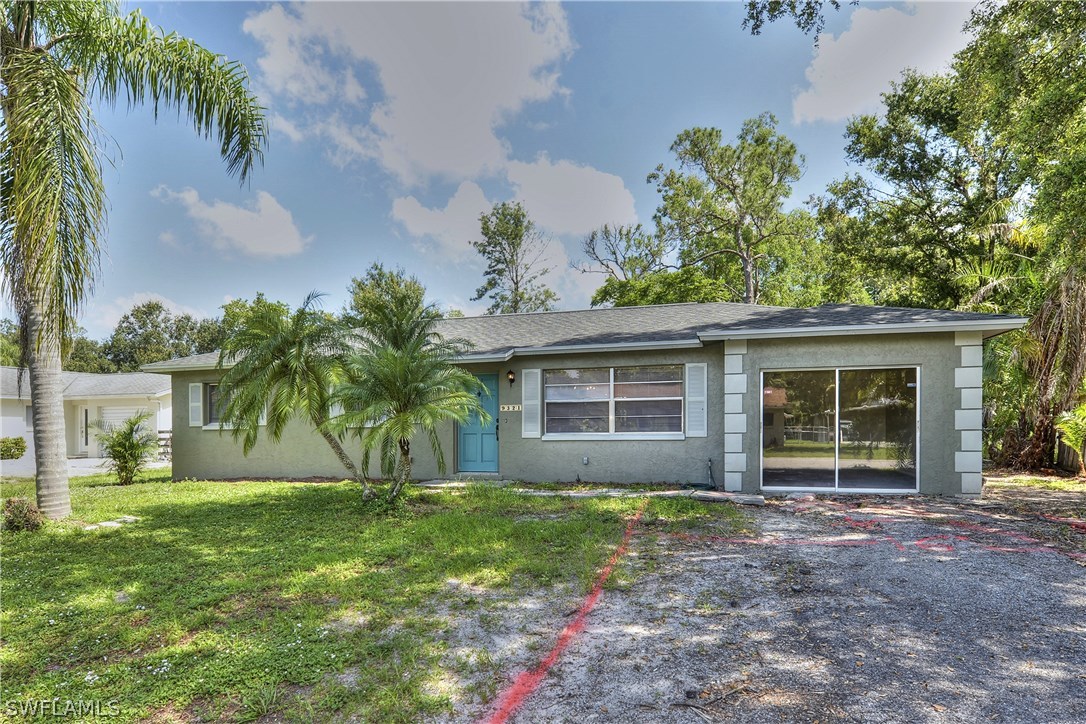 9321 Sedgefield Road North Fort Myers, FL 33917 - Photo 2 of 26 front view of house with a yard