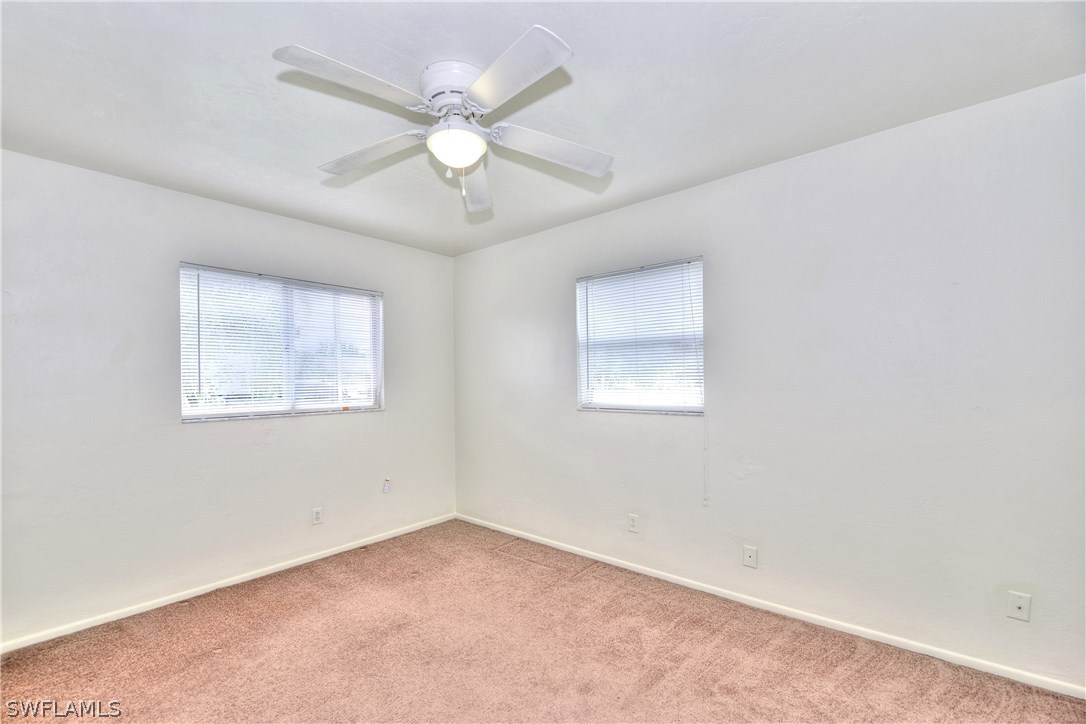 9321 Sedgefield Road North Fort Myers, FL 33917 - Photo 21 of 26 an empty room with a window and a fan