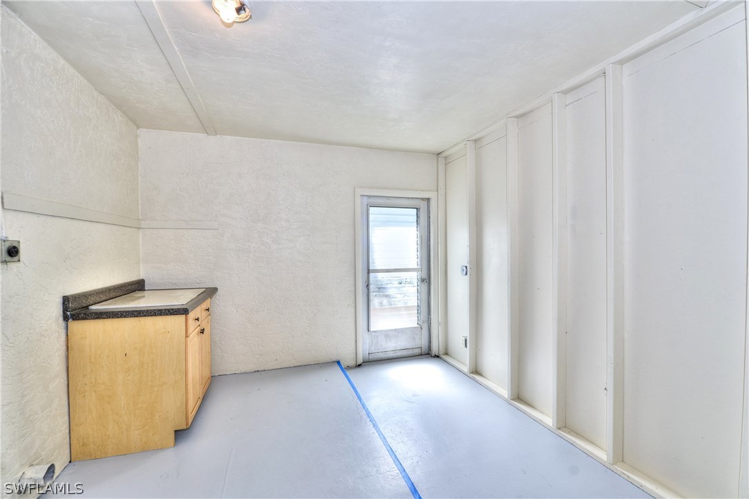 9321 Sedgefield Road North Fort Myers, FL 33917 - Photo 23 of 26 a view of an empty room with a window