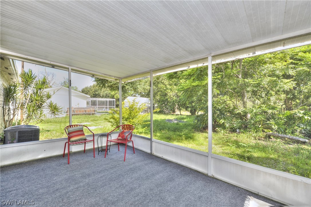 9321 Sedgefield Road North Fort Myers, FL 33917 - Photo 24 of 26 a view of a porch with furniture and garden