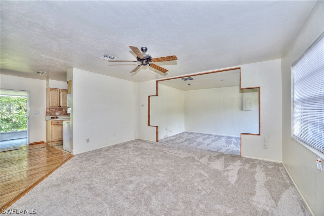 9321 Sedgefield Road North Fort Myers, FL 33917 - Photo 3 of 26 a view of empty room with wooden floor and window