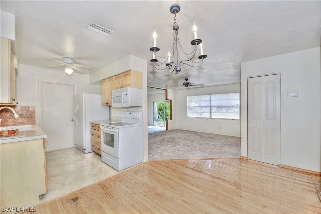 9321 Sedgefield Road North Fort Myers, FL 33917 - Photo 5 of 26 a view of a kitchen with refrigerator and cabinets