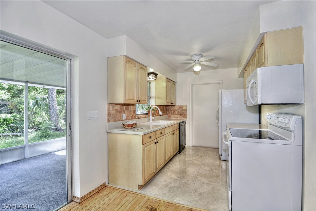 9321 Sedgefield Road North Fort Myers, FL 33917 - Photo 6 of 26 a kitchen with a sink stove and cabinets