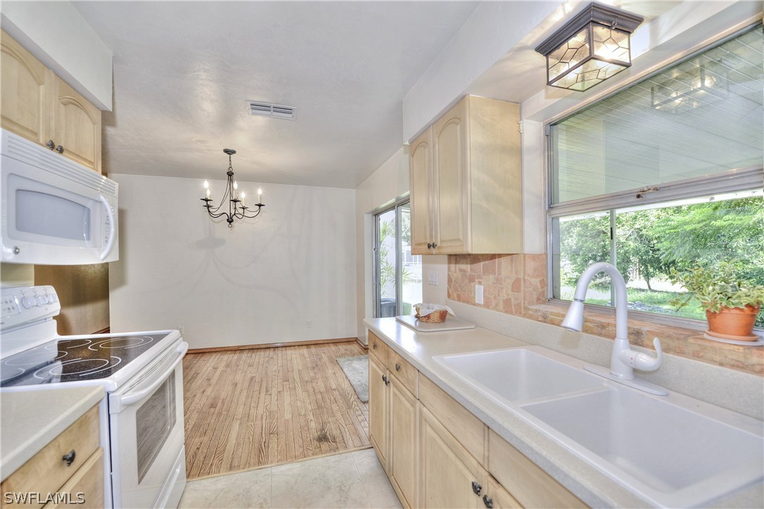 9321 Sedgefield Road North Fort Myers, FL 33917 - Photo 7 of 26 a spacious bathroom with a sink a large mirror and a bathtub