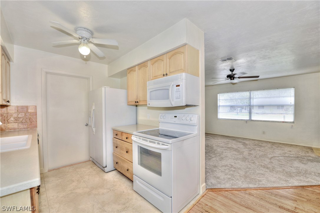 9321 Sedgefield Road North Fort Myers, FL 33917 - Photo 8 of 26 a kitchen with a stove and a microwave