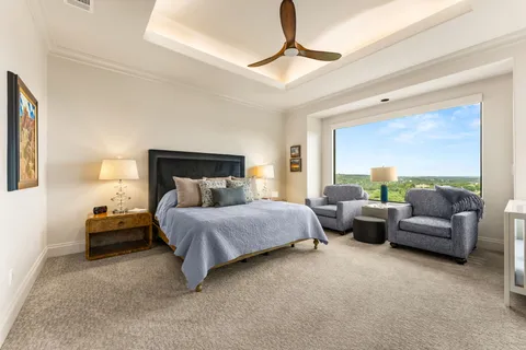 a spacious bedroom with a bed and couch