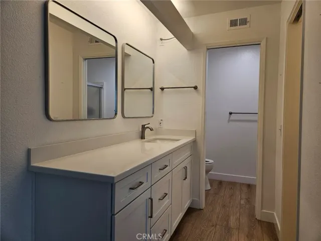 a bathroom with a sink a light fixture a vanity and a mirror