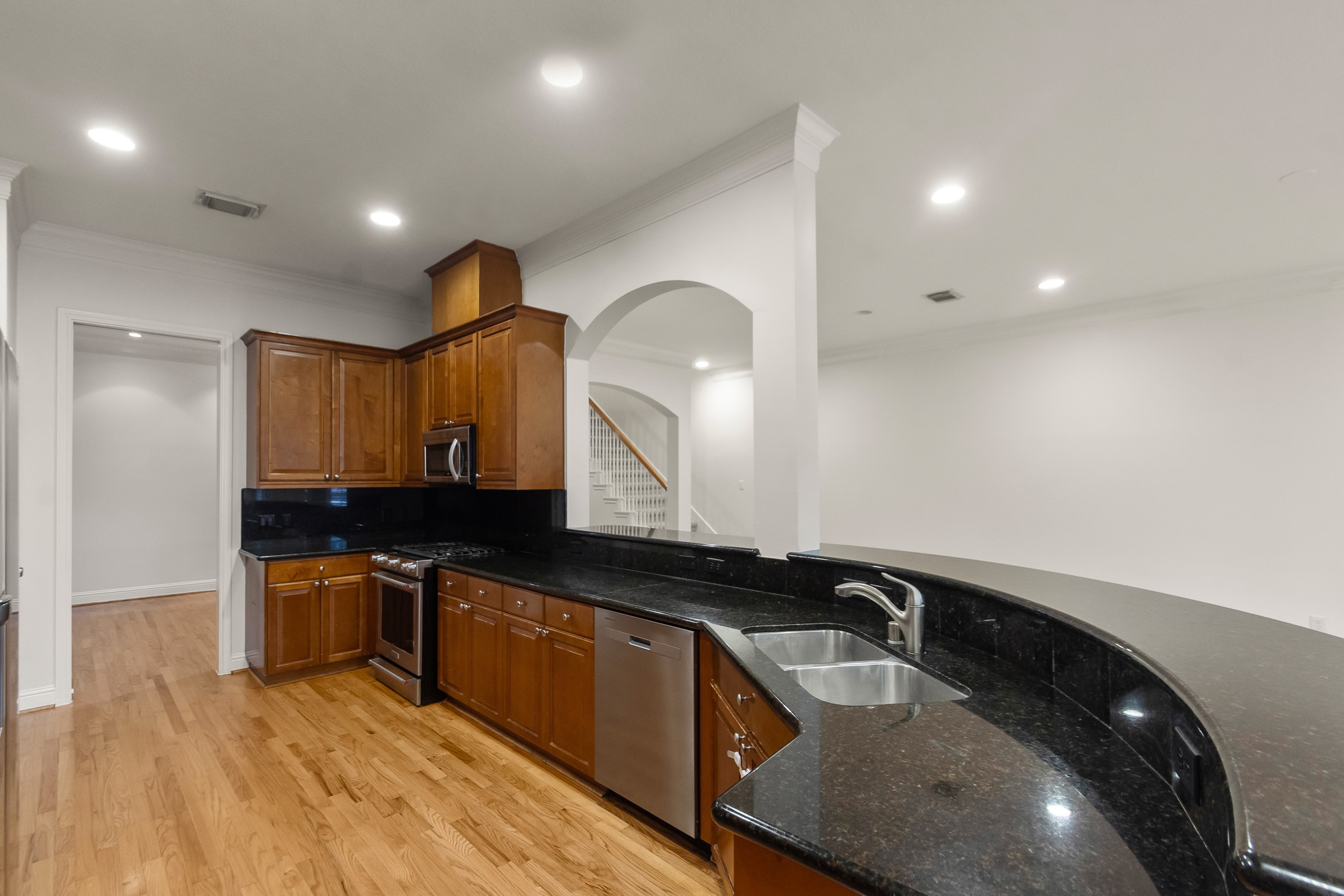 5351 McCulloch Circle Houston, TX 77056 - Photo 16 of 42 a kitchen with granite countertop a sink a stove and cabinets