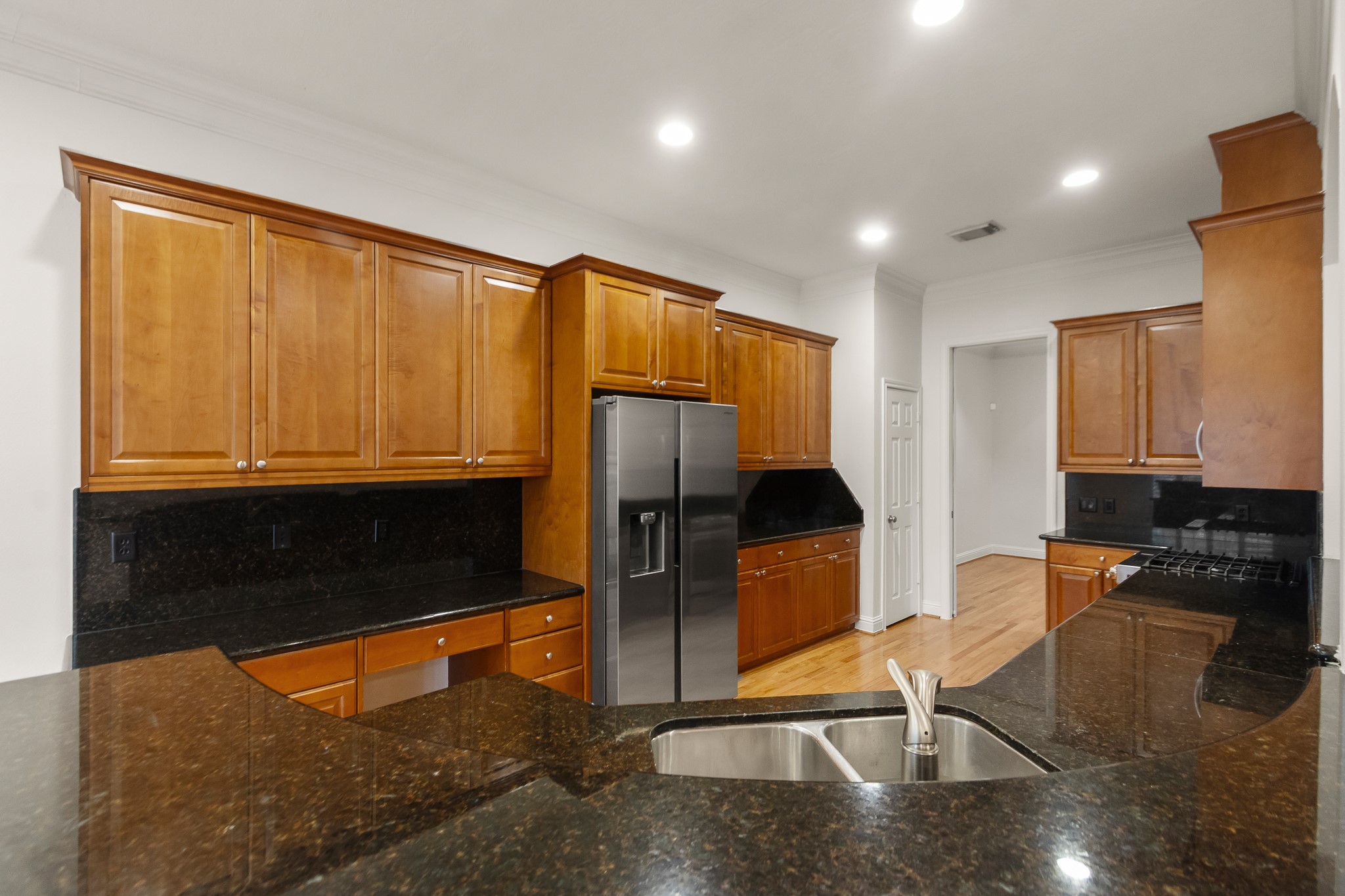 5351 McCulloch Circle Houston, TX 77056 - Photo 17 of 42 a kitchen with stainless steel appliances wooden cabinets a stove and a refrigerator