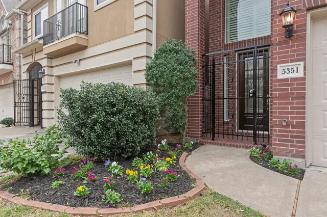 a view of a house with potted plants