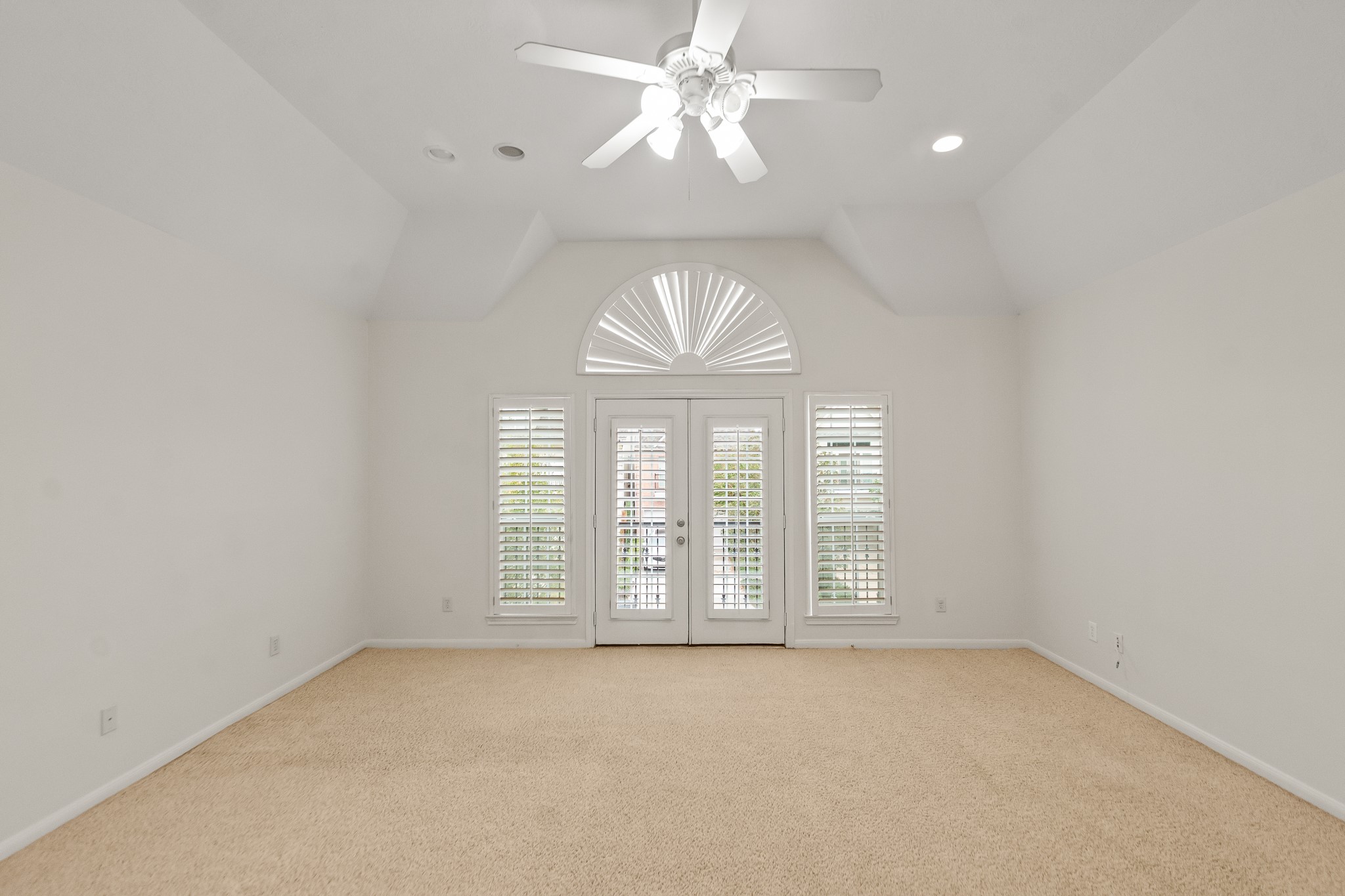 5351 McCulloch Circle Houston, TX 77056 - Photo 22 of 42 an empty room with windows and chandelier fan