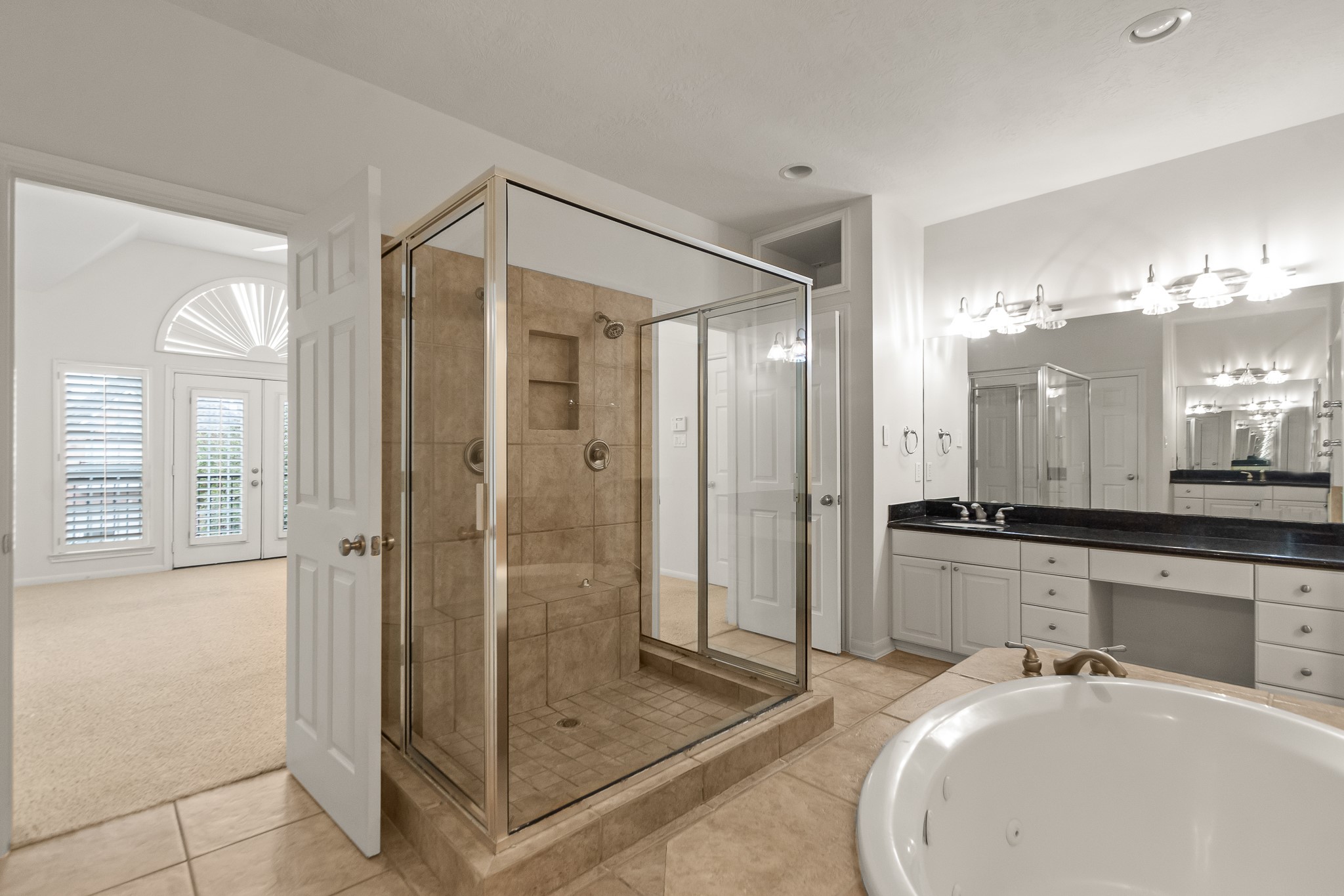 5351 McCulloch Circle Houston, TX 77056 - Photo 24 of 42 a bathroom with a glass shower door and a sink