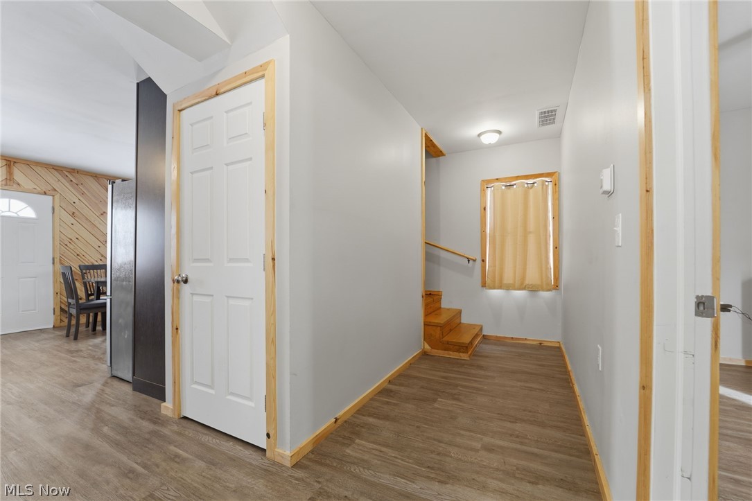 5919 Lake Road West, Unit 33 Ashtabula, OH 44004 - Photo 14 of 22 Hallway featuring wood walls and wood finished floors