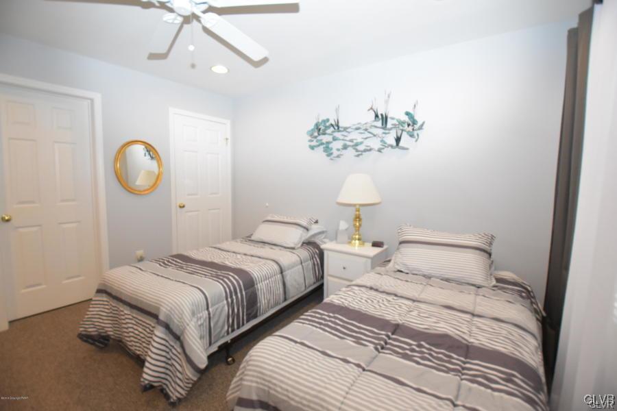 144 Indian Trail Road Jim Thorpe, PA 18229 - Photo 18 of 46 a bedroom with bed and a chandelier