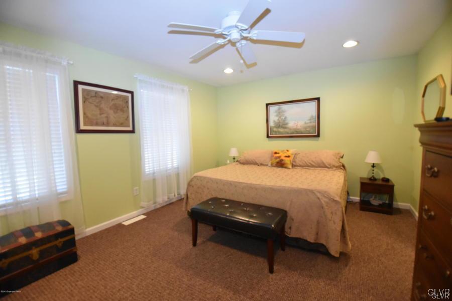 144 Indian Trail Road Jim Thorpe, PA 18229 - Photo 20 of 46 a bedroom with a bed and a painting on the wall