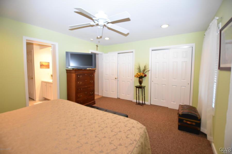 144 Indian Trail Road Jim Thorpe, PA 18229 - Photo 21 of 46 a bedroom with a bed and a chandelier