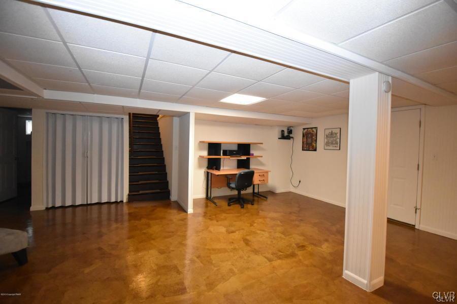 144 Indian Trail Road Jim Thorpe, PA 18229 - Photo 26 of 46 a view of a livingroom with a chair and wooden floor