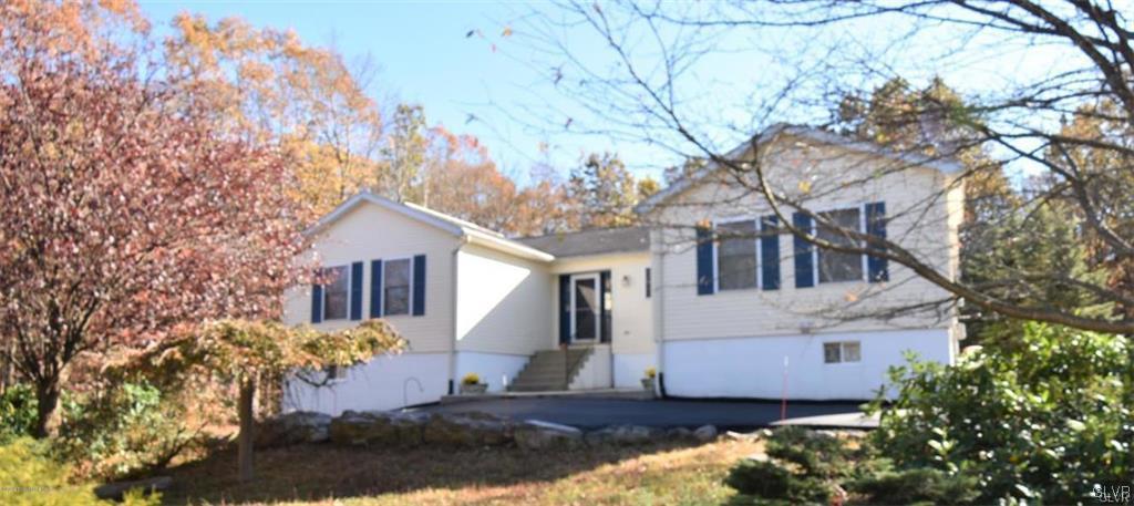 144 Indian Trail Road Jim Thorpe, PA 18229 - Photo 37 of 46 a view of a white house next to a road with large trees