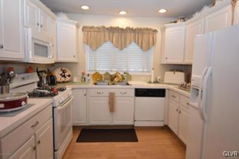 144 Indian Trail Road Jim Thorpe, PA 18229 - Photo 7 of 46 a kitchen with white cabinets and white appliances