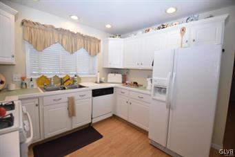 144 Indian Trail Road Jim Thorpe, PA 18229 - Photo 8 of 46 a kitchen with white cabinets and white appliances