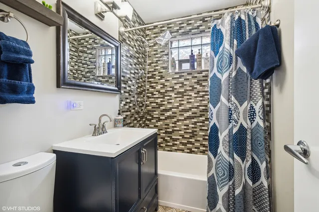 a bathroom with a sink toilet and shower