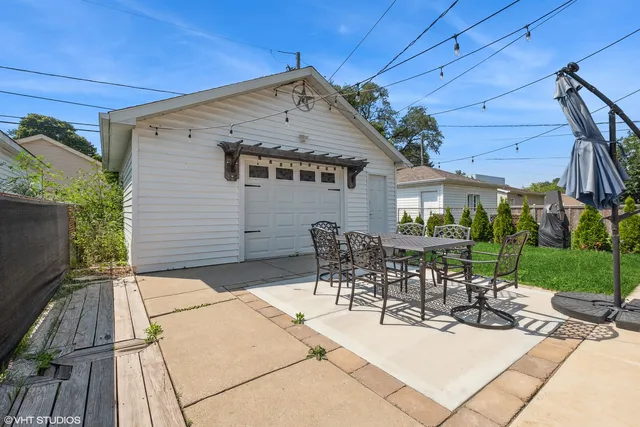 a view of a patio with table and chairs and potted plants