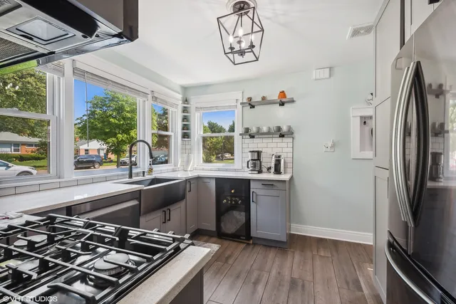 a kitchen with a refrigerator and a sink