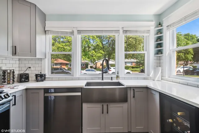 a kitchen with a sink a window and cabinets