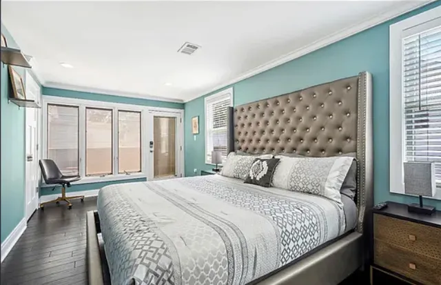 a bedroom with a large bed and a large window