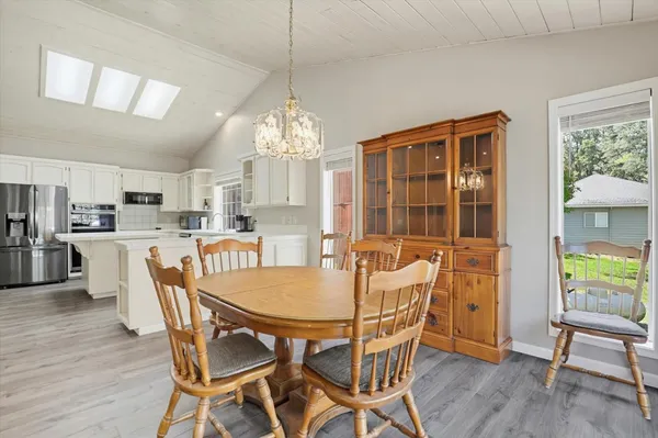 a large white kitchen with stainless steel appliances