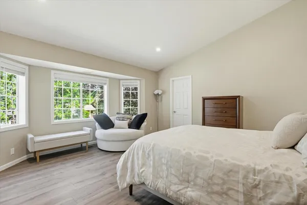 a bedroom with a large bed and a couch