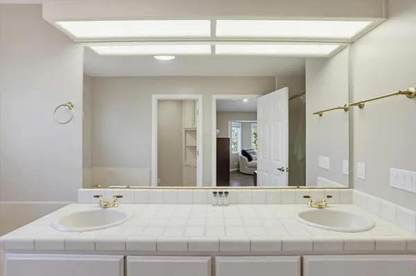 a bathroom with a bathtub a sink and a mirror