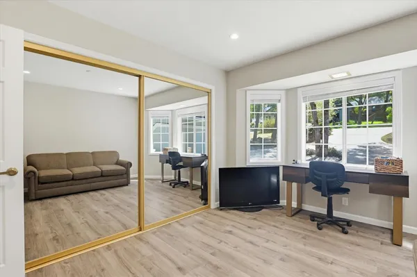 a living room with furniture and a wooden floor