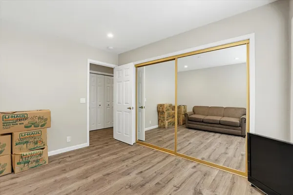 a bedroom with a bed and a chair