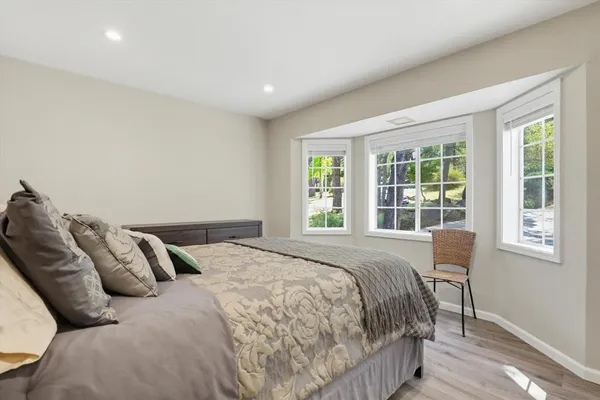 a bedroom with a bed and a night stand