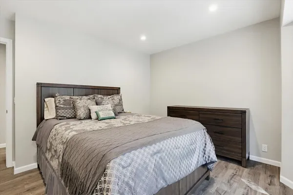 a bedroom with a bed and a mirror