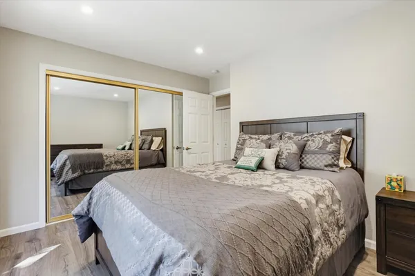 a bedroom with a large bed and a window