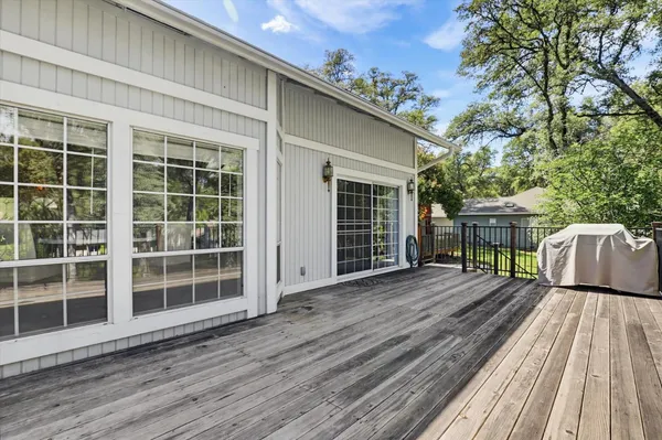 a view of backyard with a deck and wooden floor