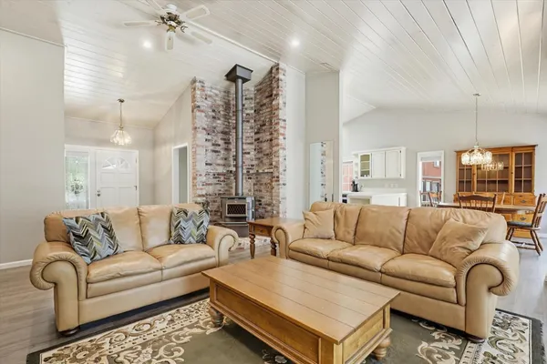 a living room with furniture ceiling fan and a rug