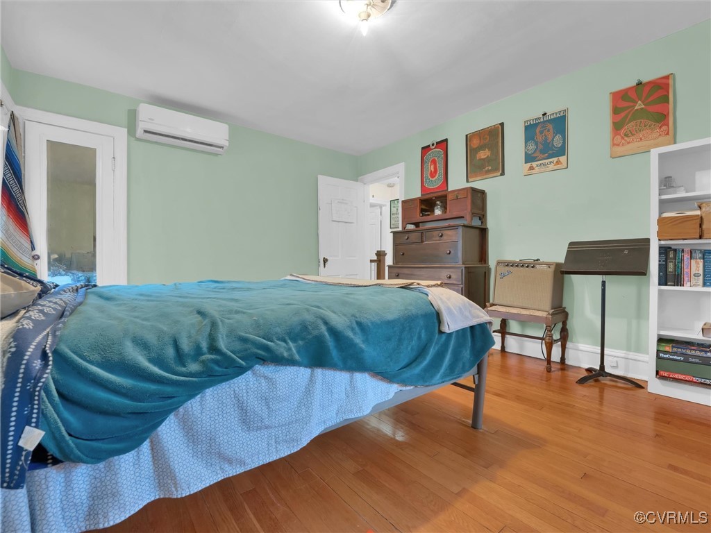 4402 Brook Road Richmond, VA 23227 - Photo 24 of 40 Bedroom with an AC wall unit and hardwood / wood-s