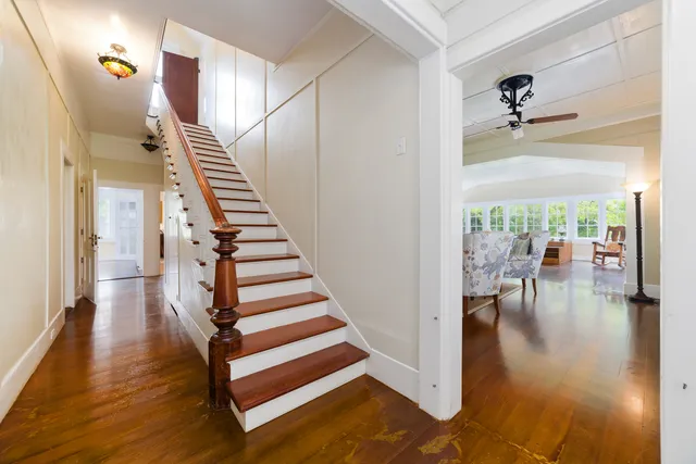 a view of entryway and hall with wooden floor