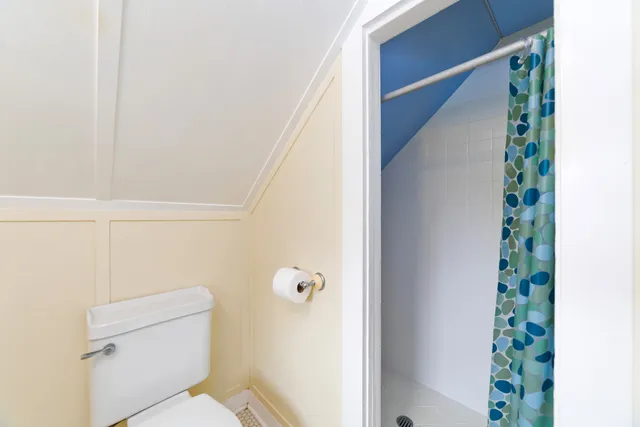 a bedroom with a bed and a chair