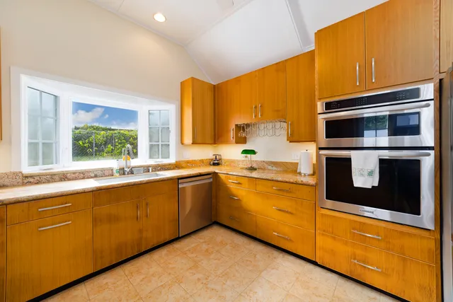 a kitchen with stainless steel appliances a stove sink and microwave