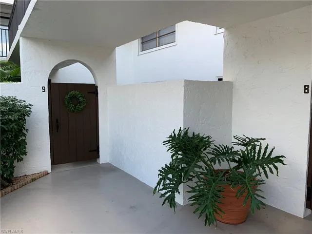 a potted plant sitting in front of a house
