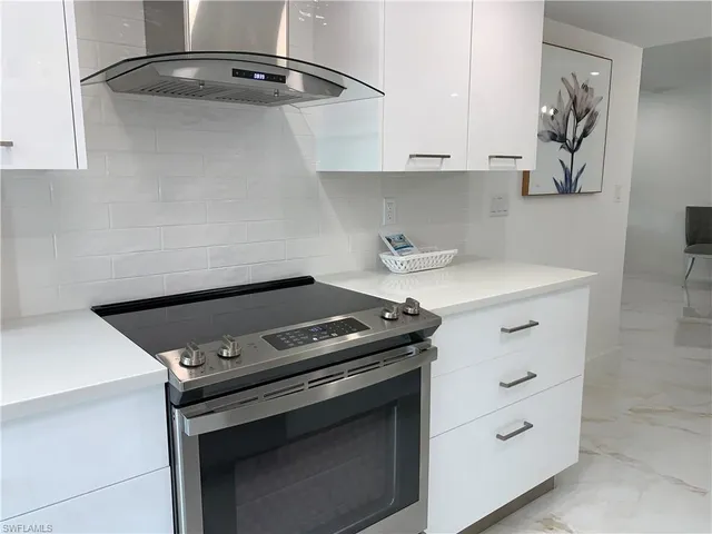 a stove top oven sitting inside of a kitchen
