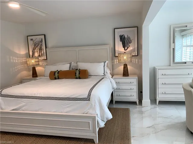 a bedroom with a bed and a mirror