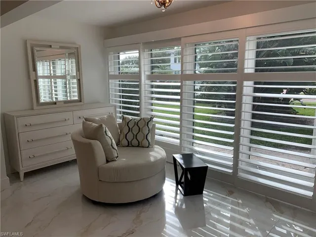 a living room with furniture and windows