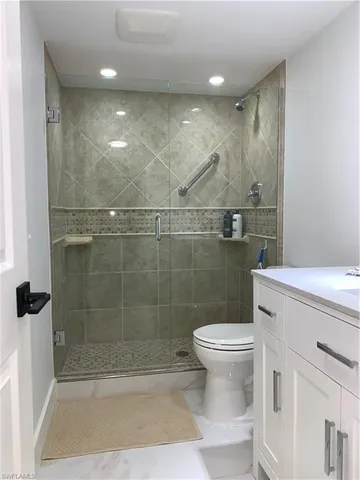 a bathroom with a toilet and a shower