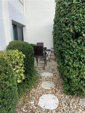 a view of a chairs and table in a backyard